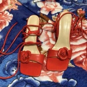 Red strappy heels with flower design